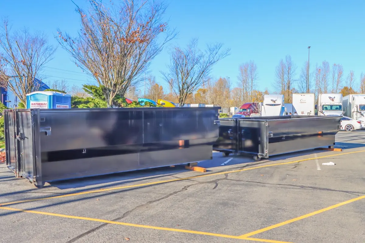 Professional dumpster rental service with roll-off container on residential driveway in Erlanger